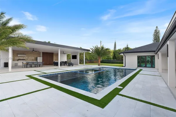 a bedroom with a large bed and a large window