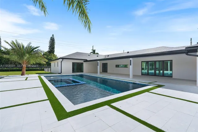 a bedroom with a bed and a view of kitchen