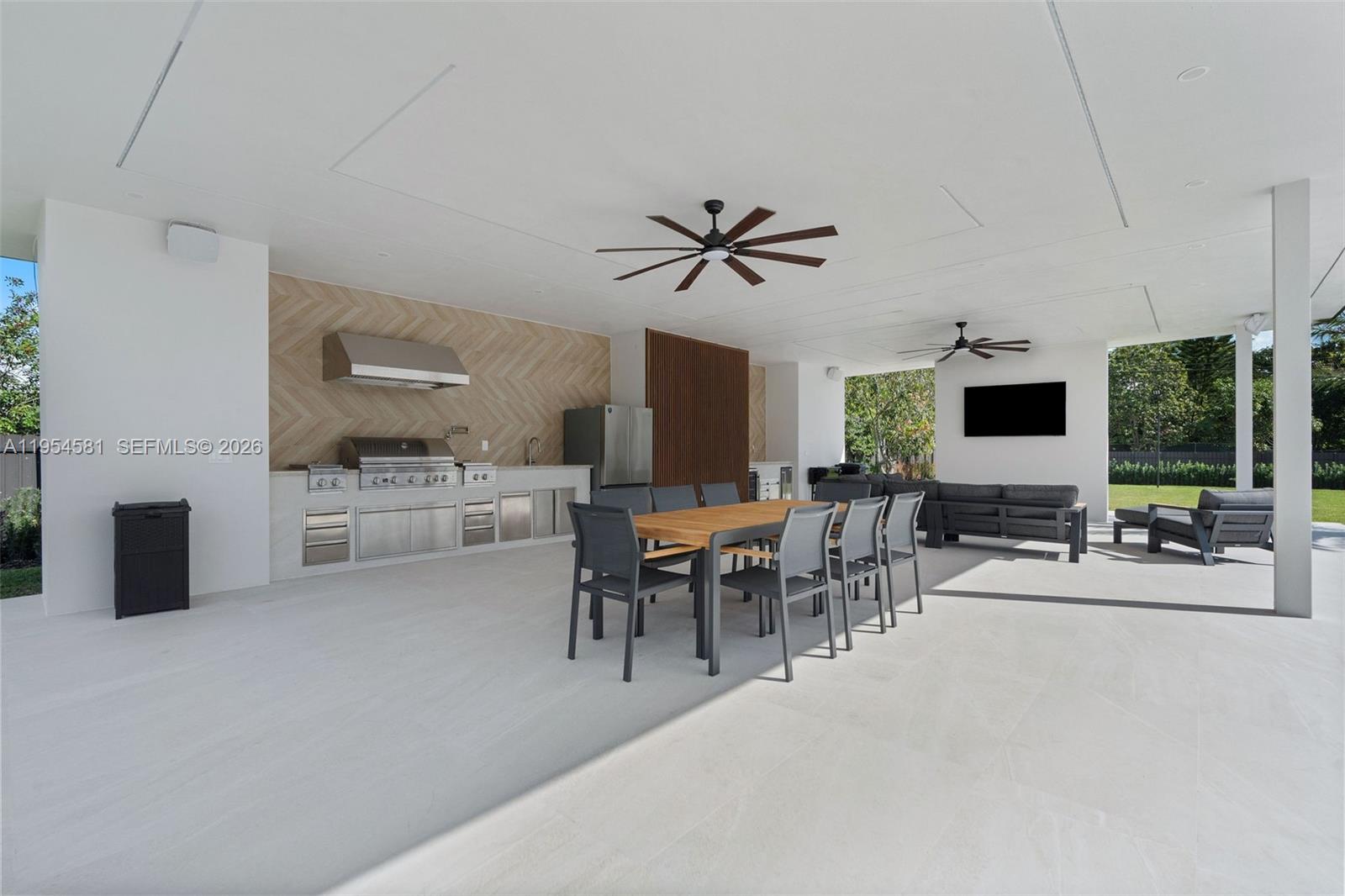 12425 Southwest 226th Street Miami, FL 33170 - Photo 34 of 75 a living room with furniture a flat screen tv and a large window