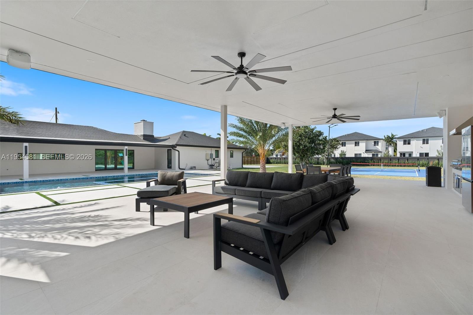 12425 Southwest 226th Street Miami, FL 33170 - Photo 35 of 75 a living room with furniture and a ceiling fan