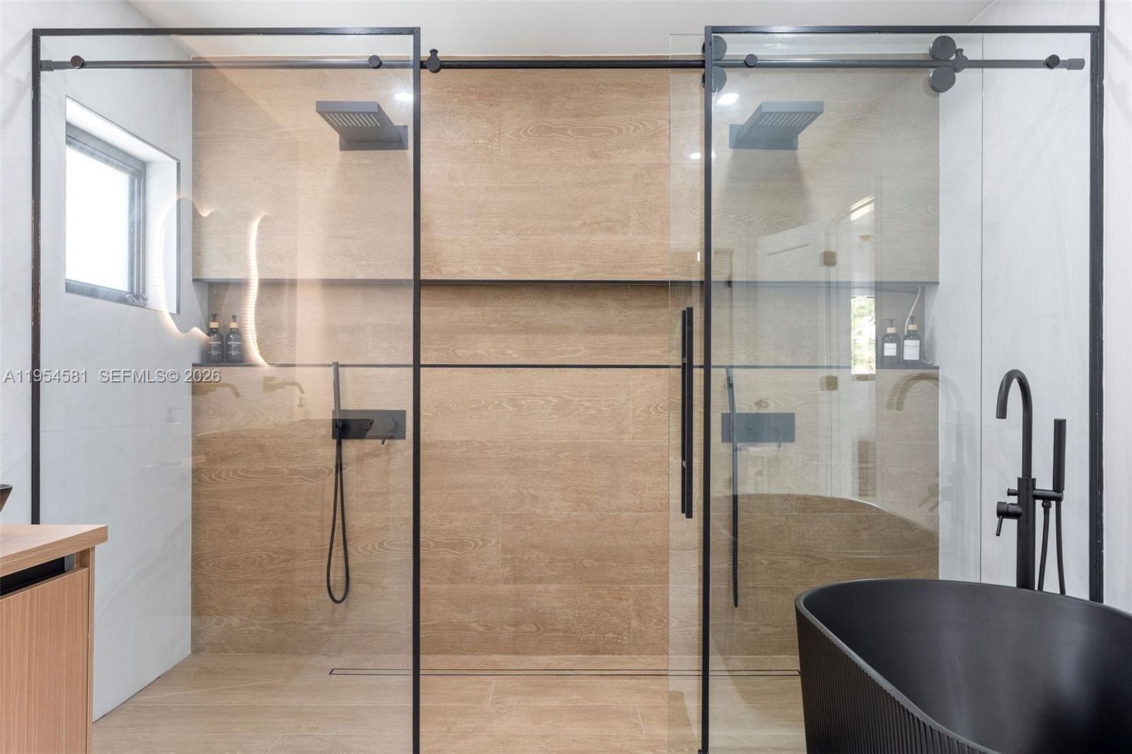 12425 Southwest 226th Street Miami, FL 33170 - Photo 40 of 75 a bathroom with a glass shower door