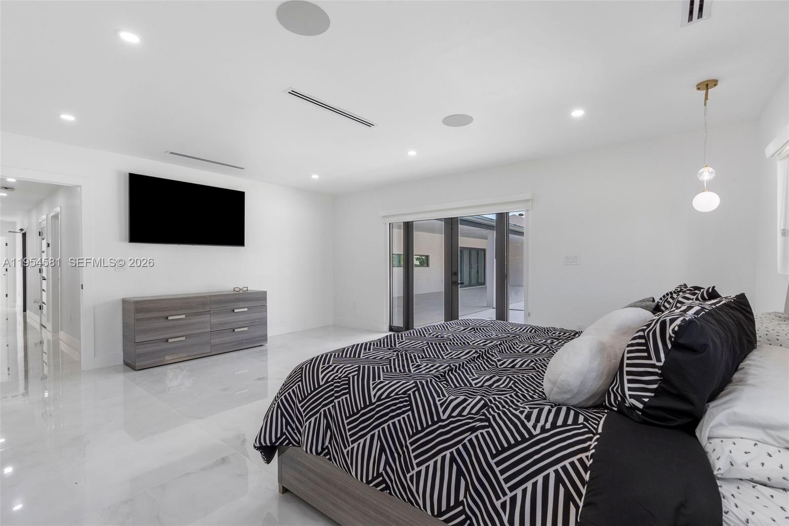 12425 Southwest 226th Street Miami, FL 33170 - Photo 43 of 75 a bedroom with a bed and a flat screen tv