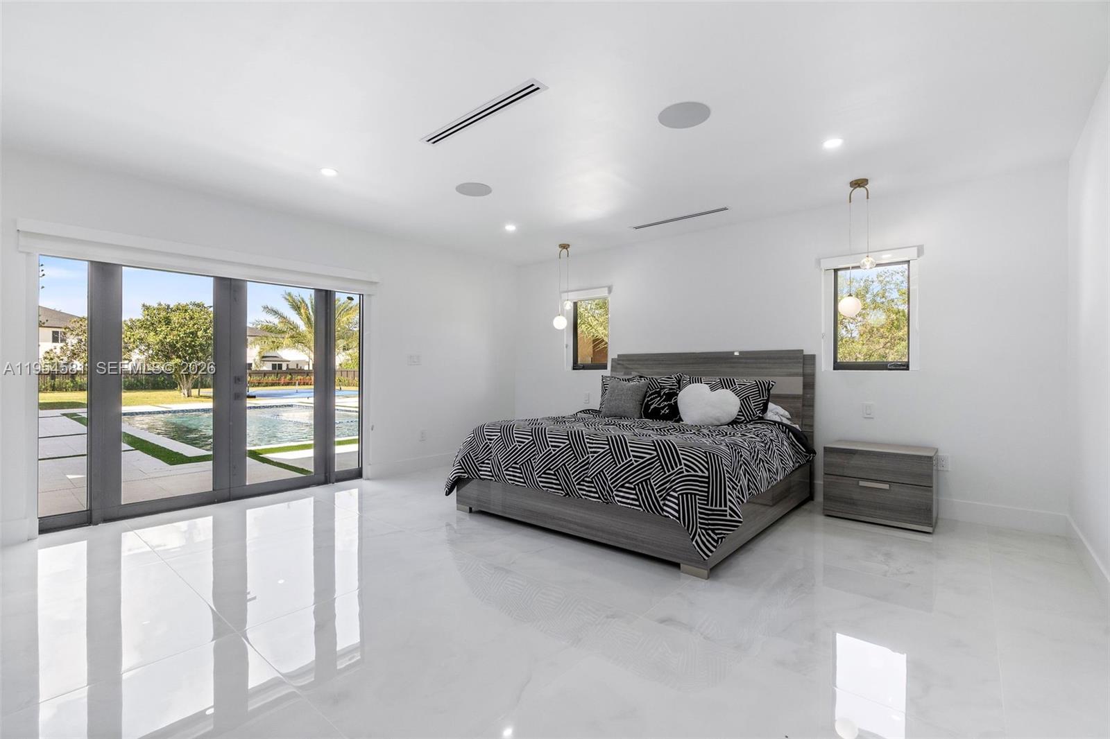 12425 Southwest 226th Street Miami, FL 33170 - Photo 44 of 75 a bedroom with a large bed and a large window