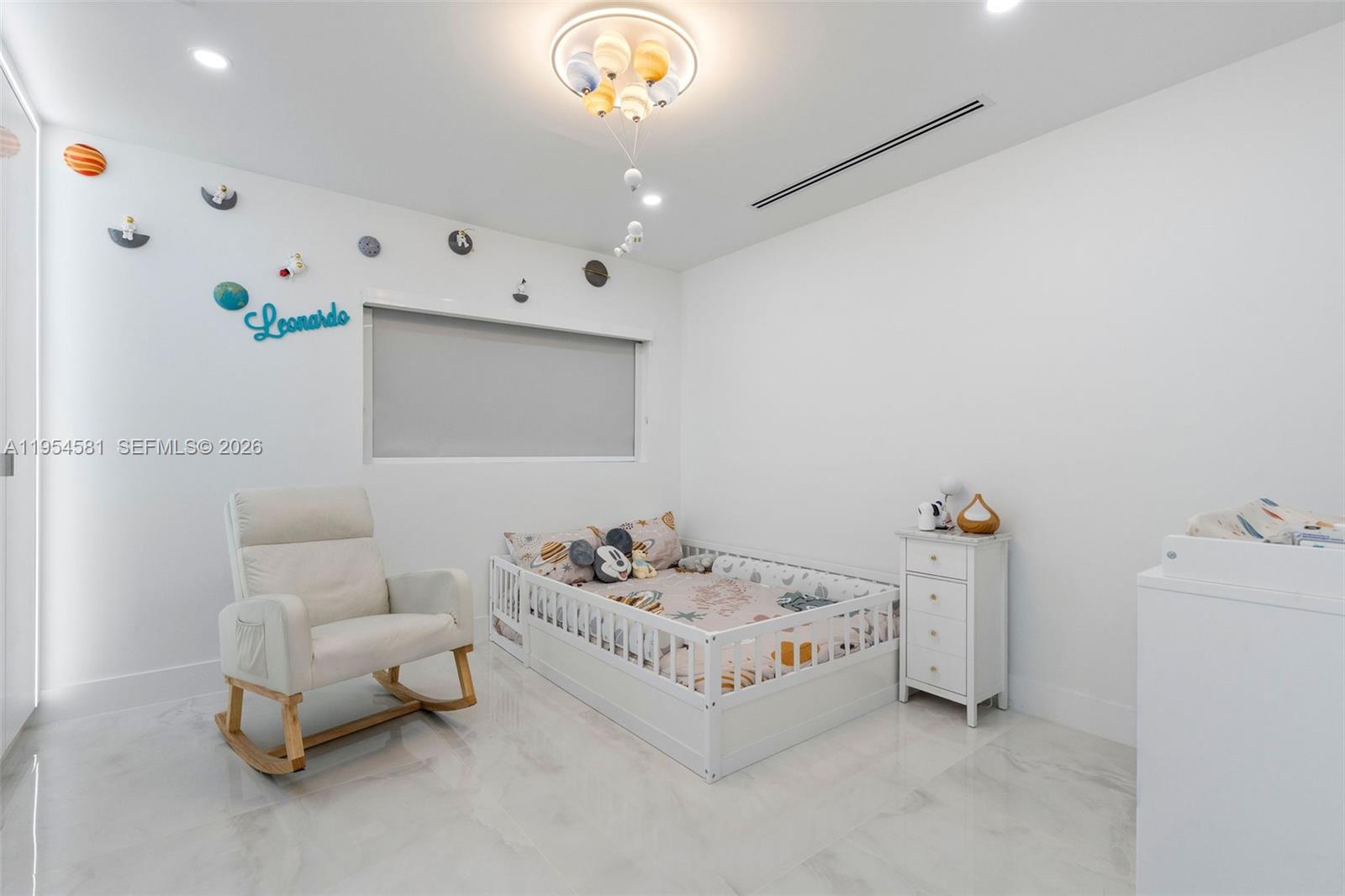 12425 Southwest 226th Street Miami, FL 33170 - Photo 48 of 75 a bedroom with a bed and a chandelier