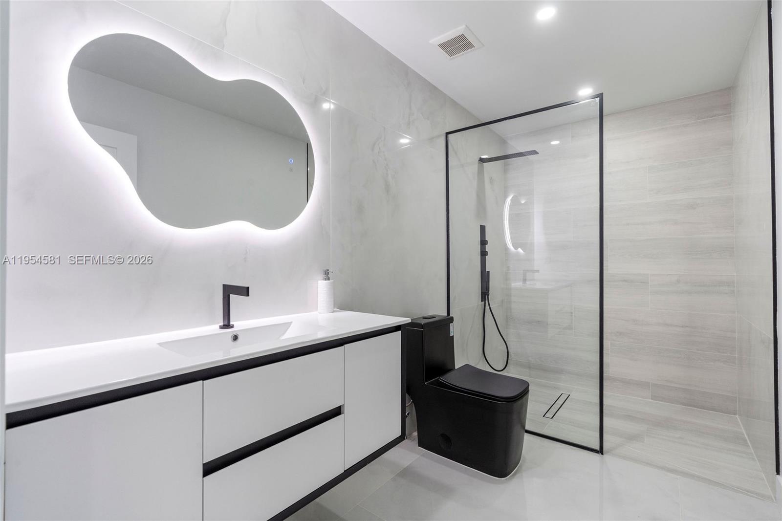 12425 Southwest 226th Street Miami, FL 33170 - Photo 49 of 75 a bathroom with a sink a toilet and a mirror