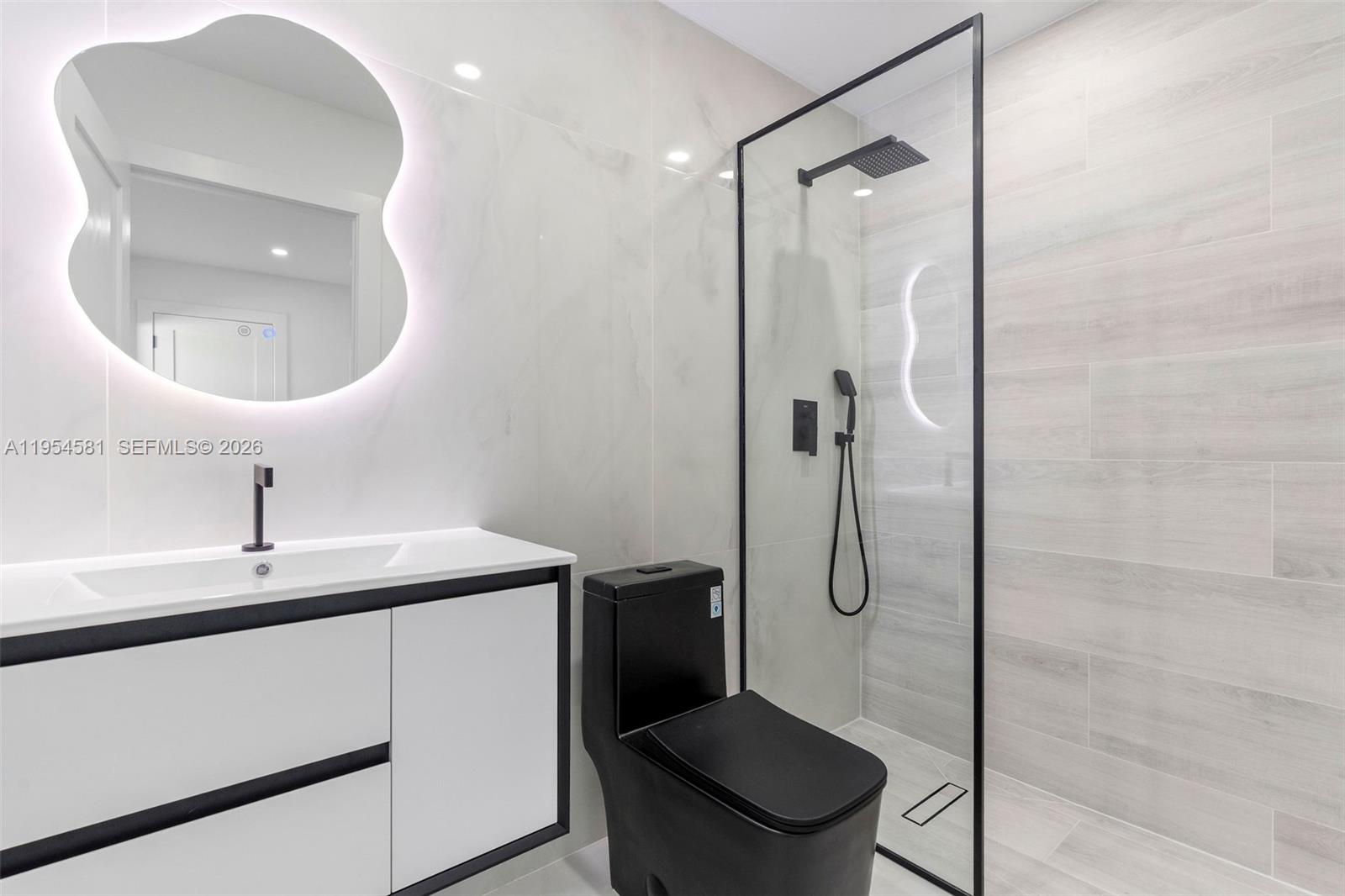 12425 Southwest 226th Street Miami, FL 33170 - Photo 54 of 75 a bathroom with a granite countertop sink a toilet and shower