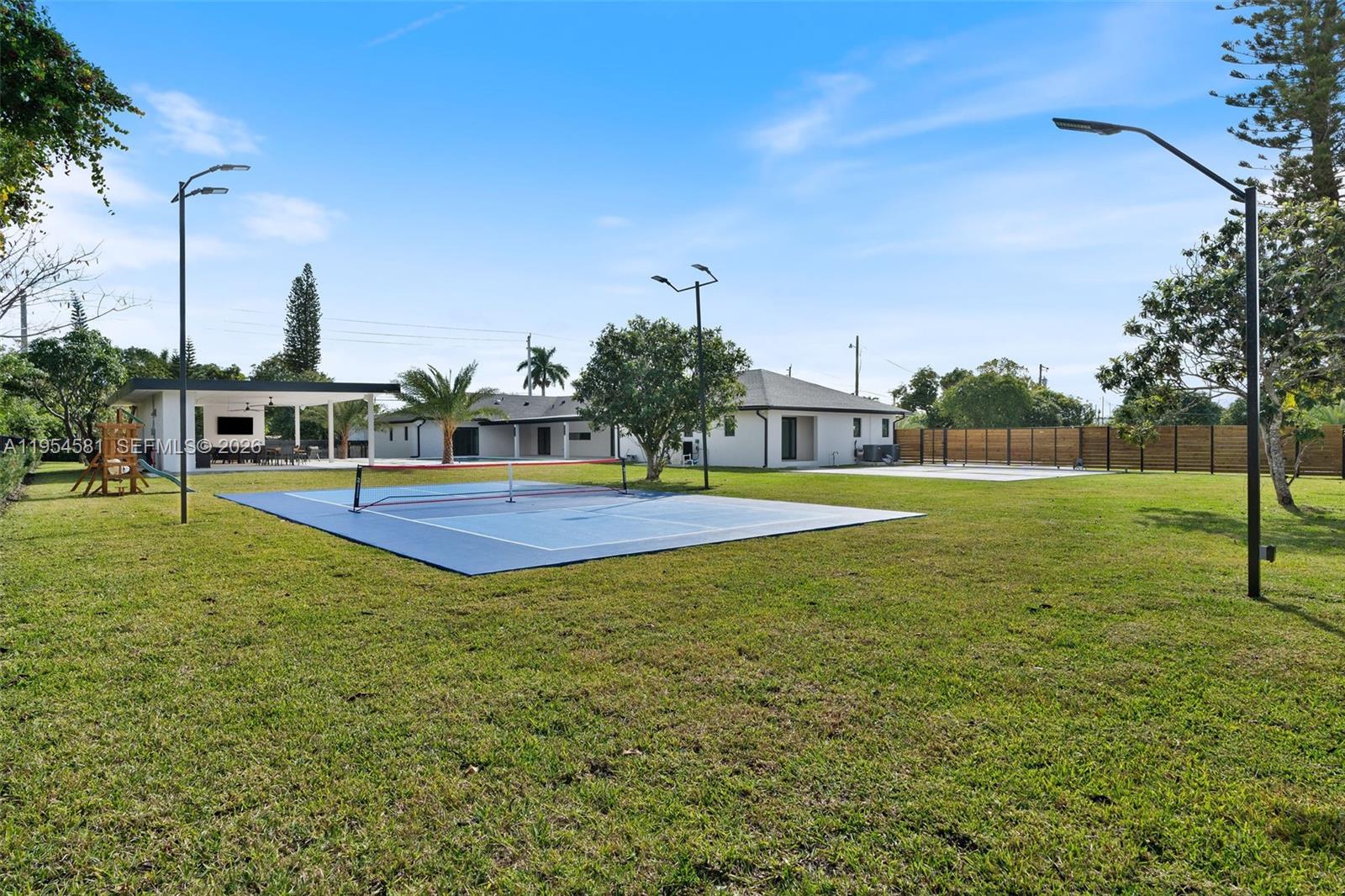 12425 Southwest 226th Street Miami, FL 33170 - Photo 67 of 75 a view of a swimming pool with a yard