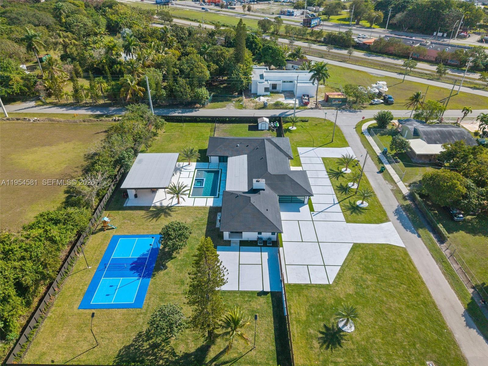 12425 Southwest 226th Street Miami, FL 33170 - Photo 68 of 75 an aerial view of a house with a swimming pool outdoor seating and yard