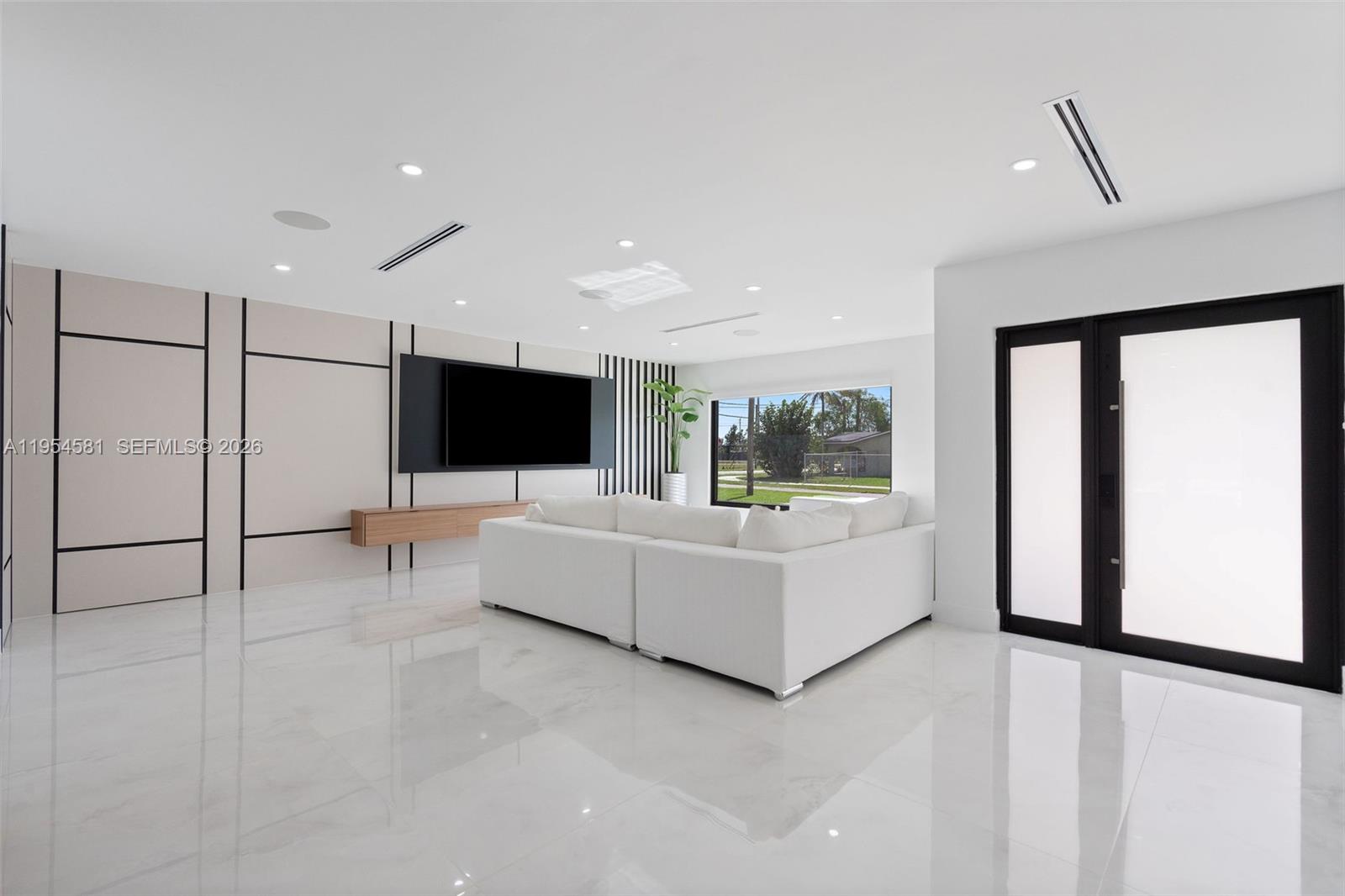 12425 Southwest 226th Street Miami, FL 33170 - Photo 8 of 75 a living room with furniture and a flat screen tv