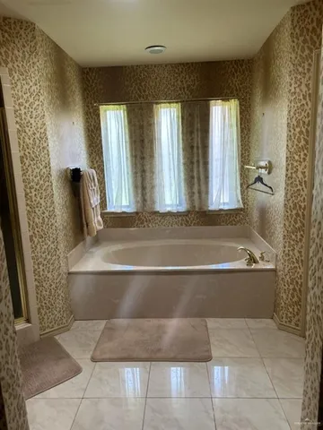 a utility room with a sink a cabinetry and utility