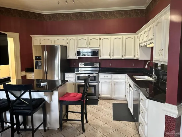 a kitchen with a stove a sink and a refrigerator