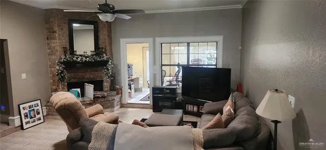 a living room with furniture a fireplace and a flat screen tv