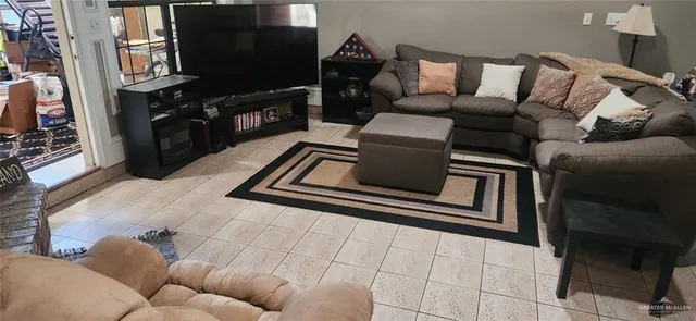 a living room with furniture and a flat screen tv