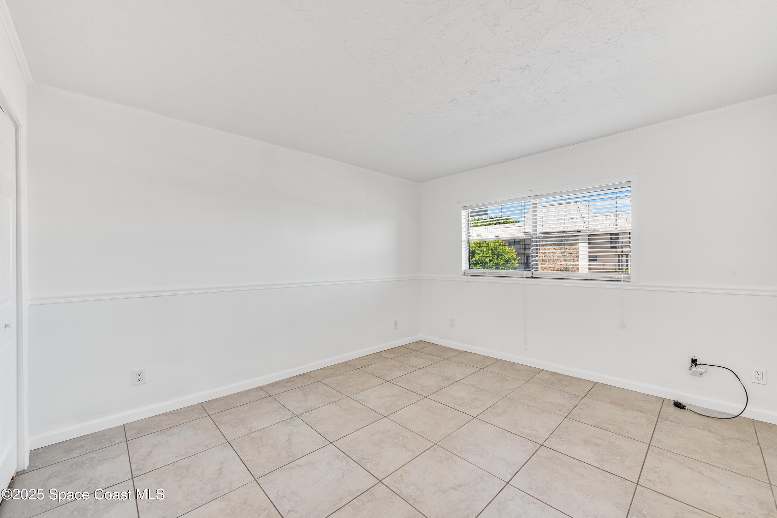 315 Tangle Run Boulevard, Unit 1023 Melbourne, FL 32940 - Photo 12 of 17 a view of an empty room with a window