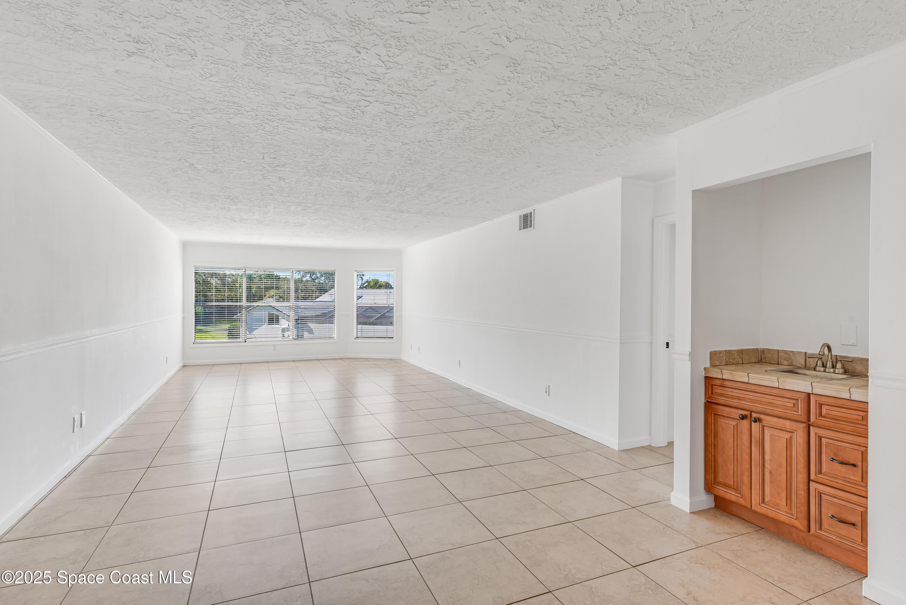 315 Tangle Run Boulevard, Unit 1023 Melbourne, FL 32940 - Photo 3 of 17 a view of an empty room and window