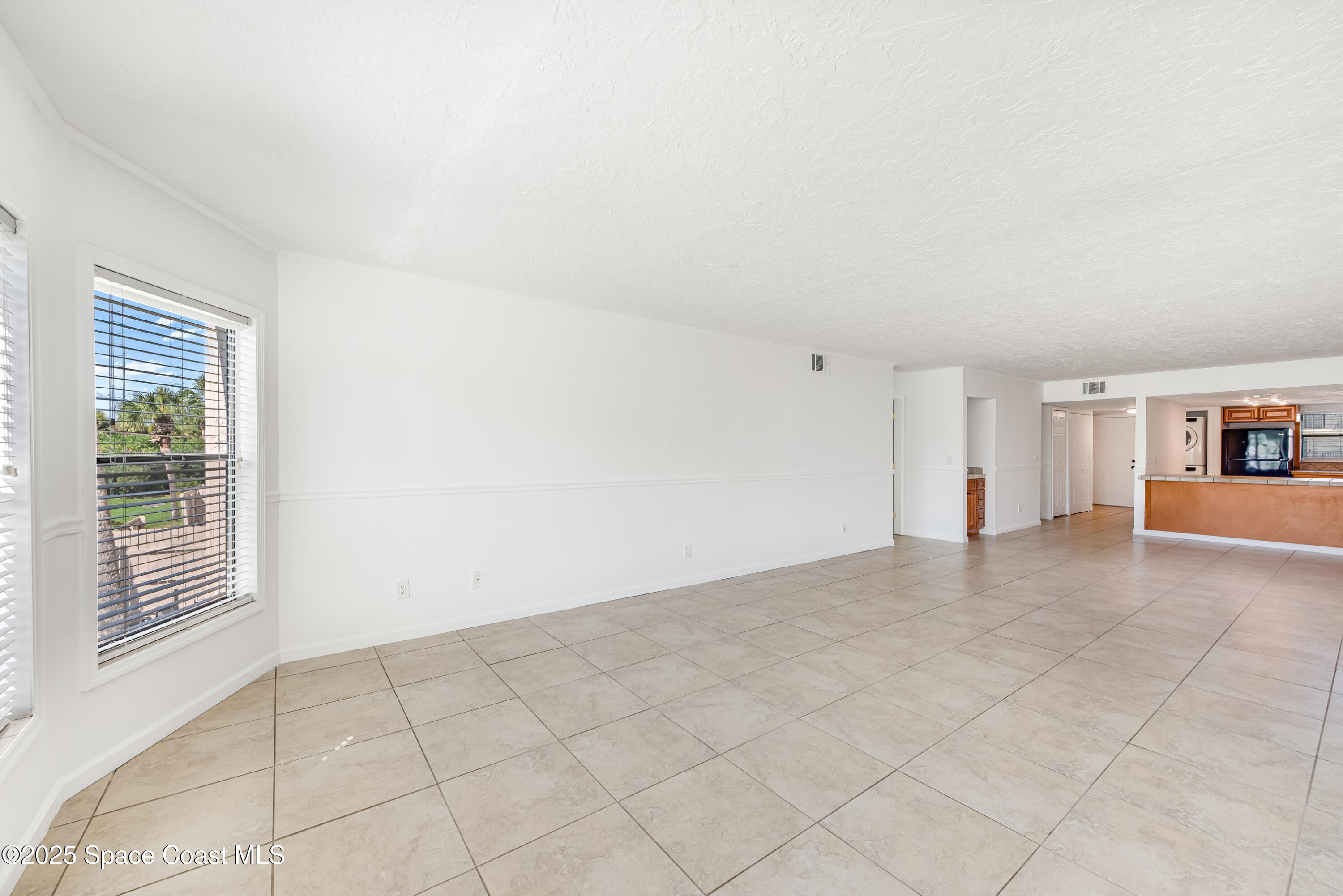 315 Tangle Run Boulevard, Unit 1023 Melbourne, FL 32940 - Photo 5 of 17 a view of an empty room with a window