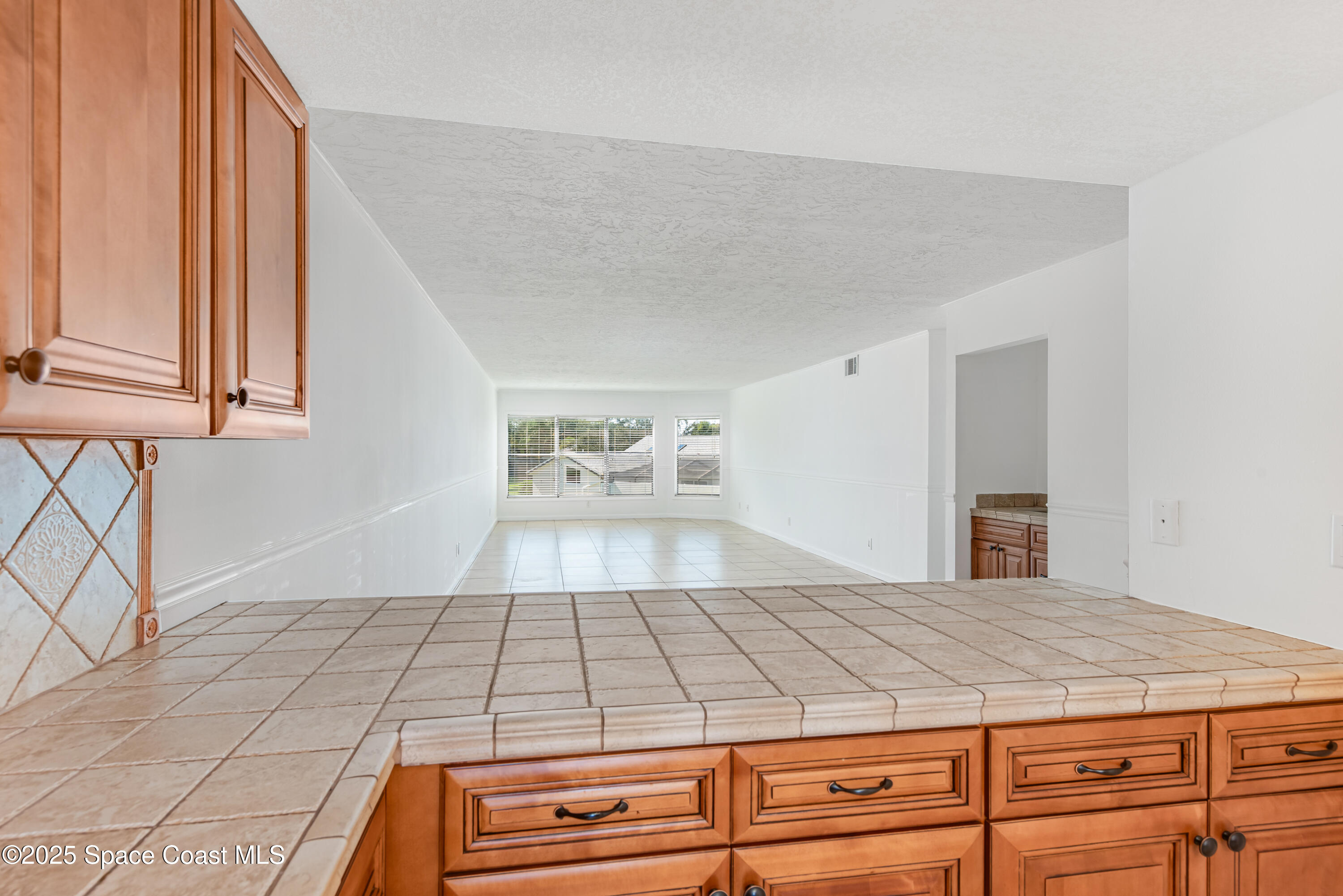 315 Tangle Run Boulevard, Unit 1023 Melbourne, FL 32940 - Photo 10 of 17 a bedroom with a bed and a window