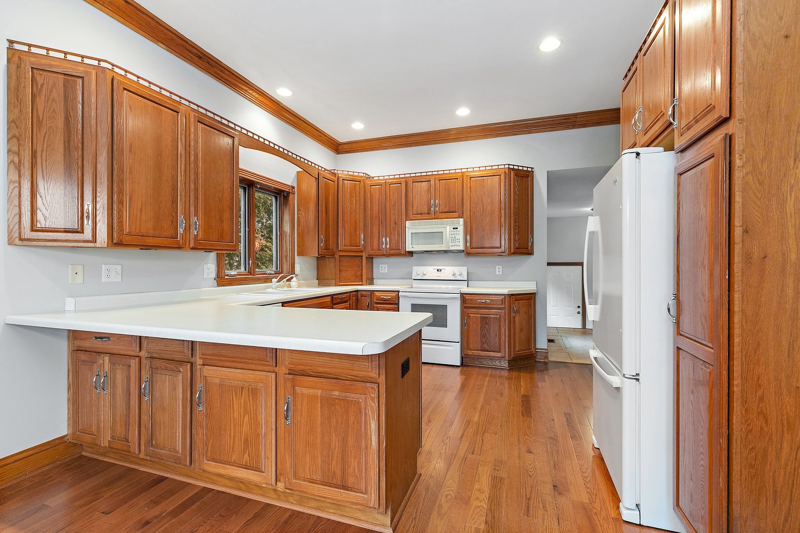5N988 Meredith Road Maple Park, IL 60151 - Photo 9 of 38 a kitchen with stainless steel appliances granite countertop a refrigerator a sink dishwasher and a stove with wooden floor