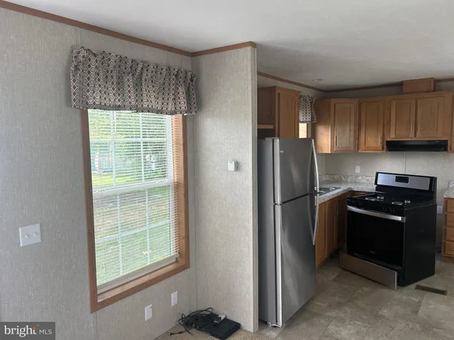 a kitchen with a refrigerator stove and cabinets