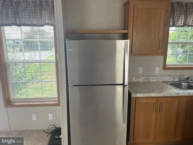 a white refrigerator freezer sitting inside of a kitchen