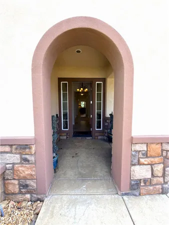 a living room with couches and a dining table with garden view