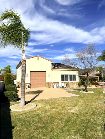 a view of a house with backyard porch and sitting area