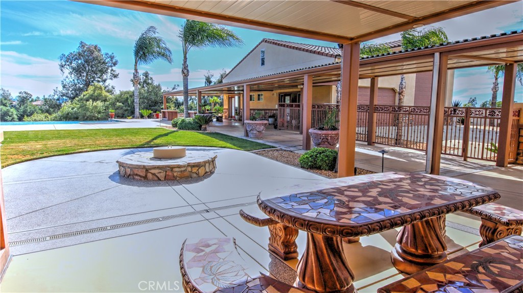 923 Union Street Cherry Valley, CA 92223 - Photo 52 of 68 a view of a patio with a table chairs and a swimming pool