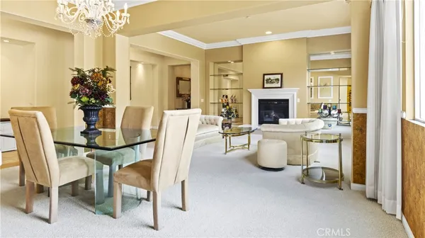 a kitchen with stainless steel appliances kitchen island granite countertop a table chairs sink and cabinets