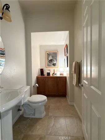 a kitchen with stainless steel appliances granite countertop a kitchen island a stove a dining table and chairs