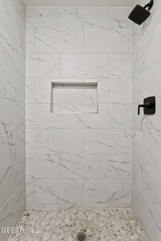 a bedroom with a bed and a potted plant