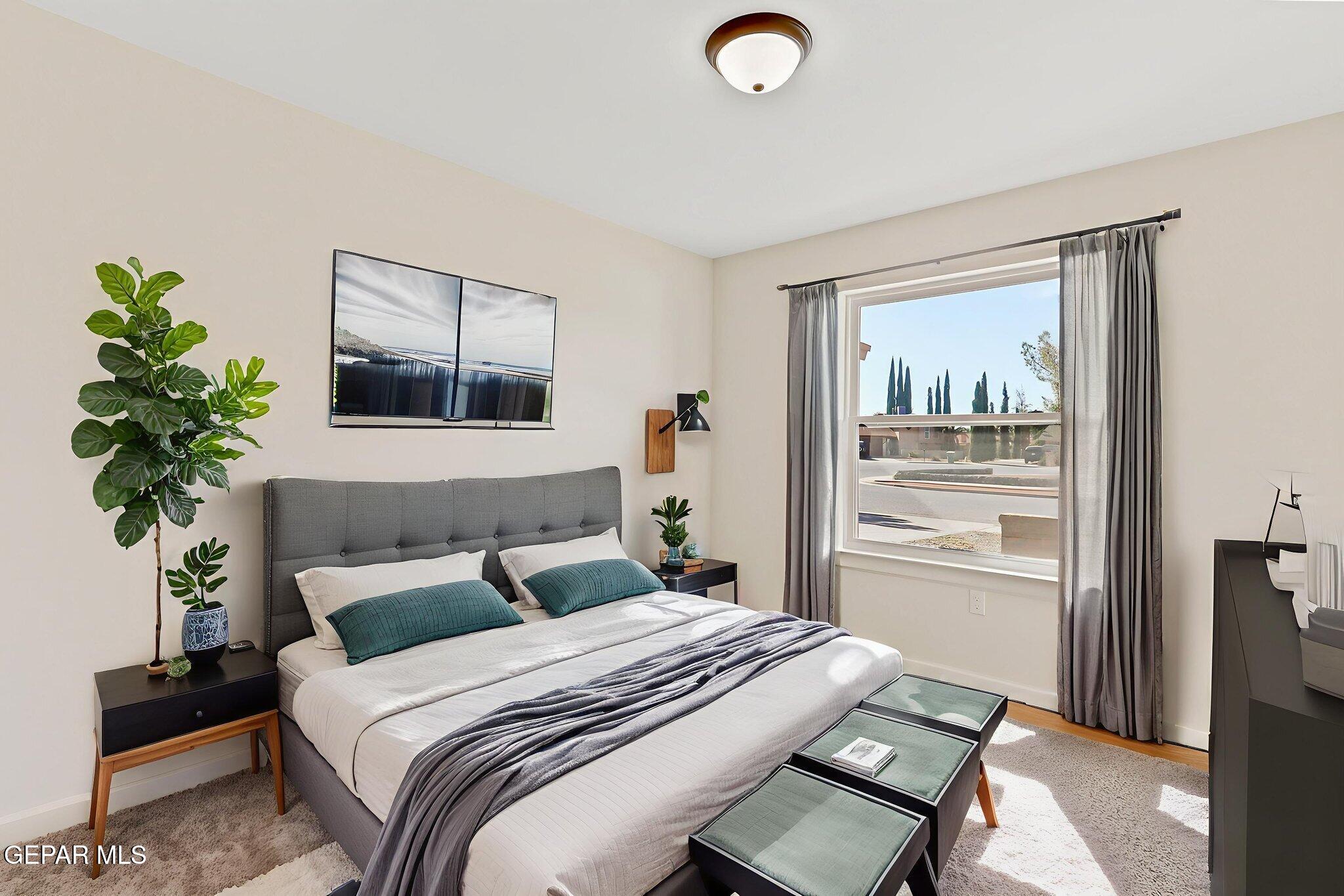 3428 Itasca Street El Paso, TX 79936 - Photo 20 of 34 a bedroom with a bed and a potted plant