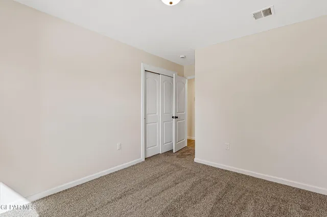 a bedroom with a bed and a potted plant