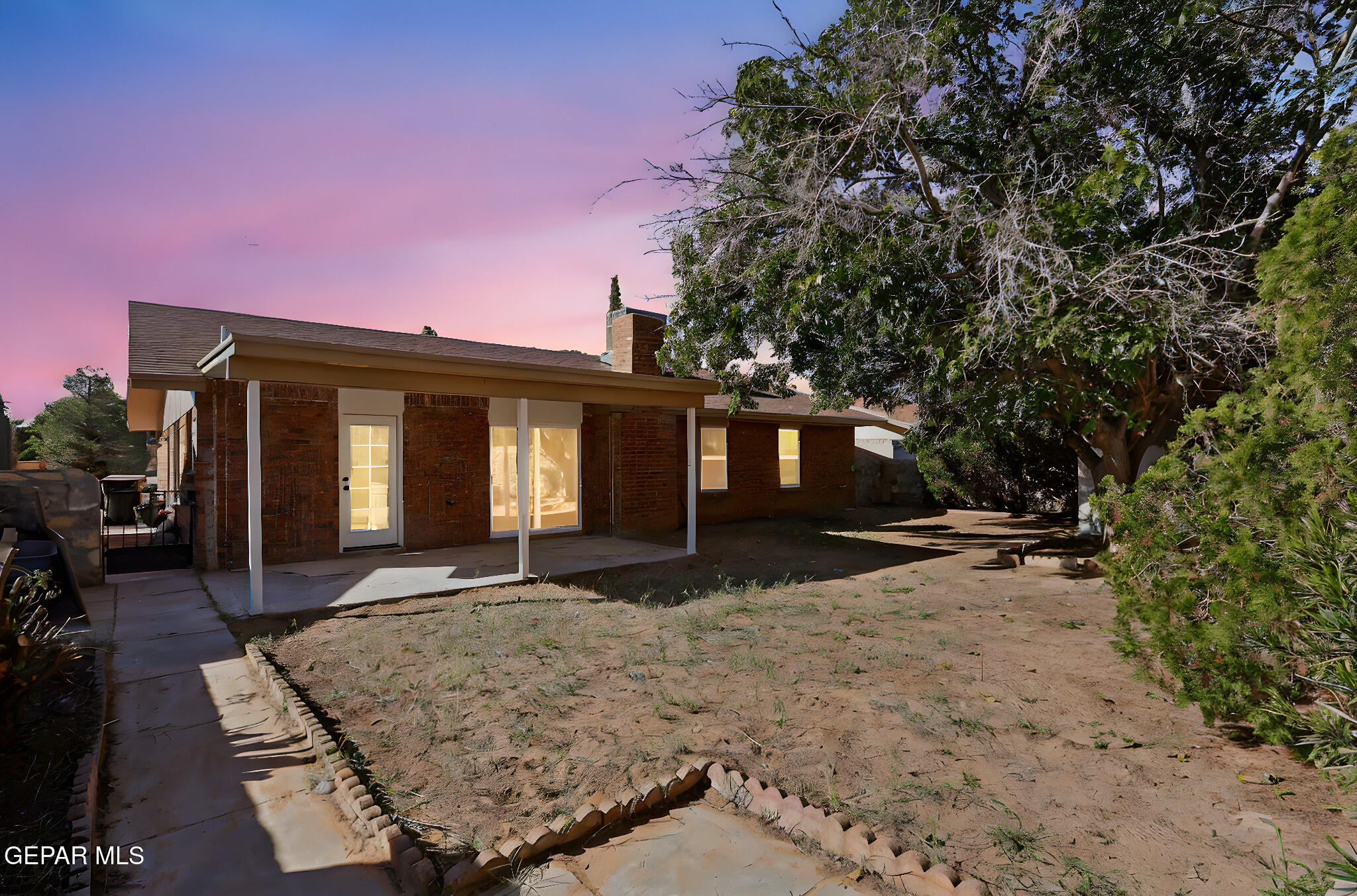 3428 Itasca Street El Paso, TX 79936 - Photo 31 of 34 a front view of a house with a yard and garage