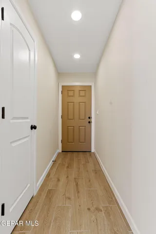 a view of empty room with wooden floor and fireplace