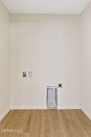 a view of kitchen with cabinets and refrigerator