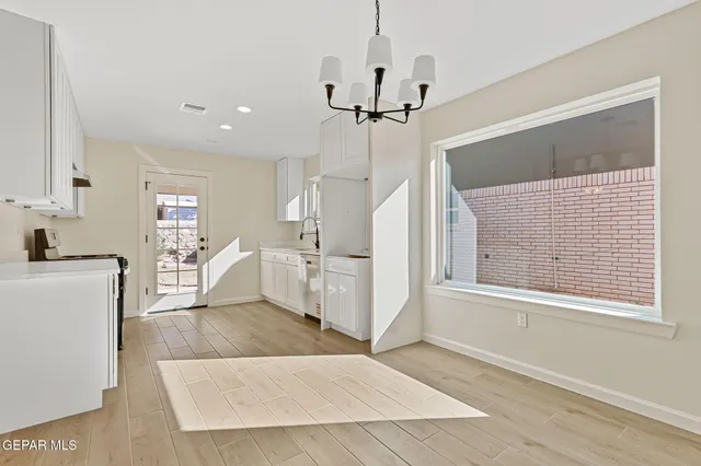 a kitchen with white cabinets and white appliances