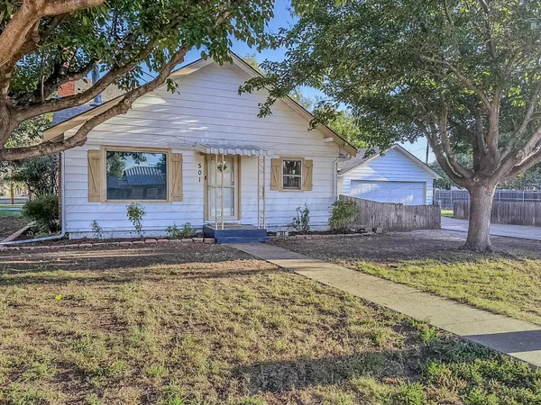 a front view of a house with swimming pool table and chairs
