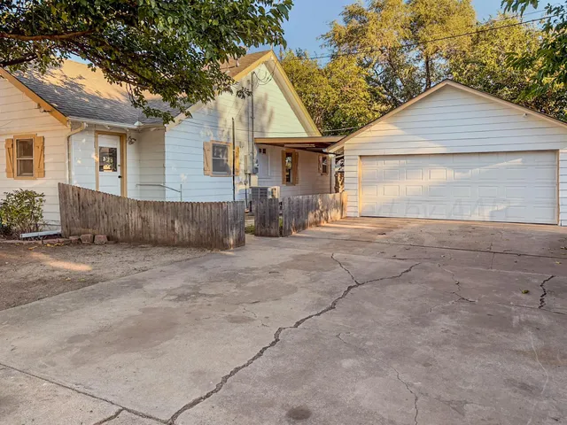 a view of a house with a yard and garage