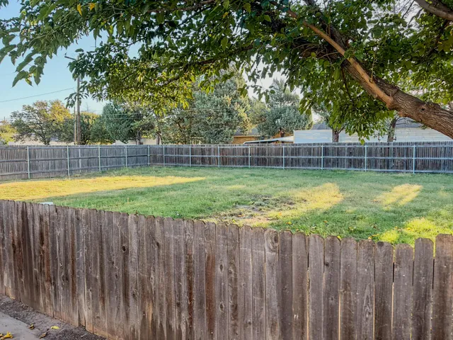 a view of a swimming pool with wooden fence