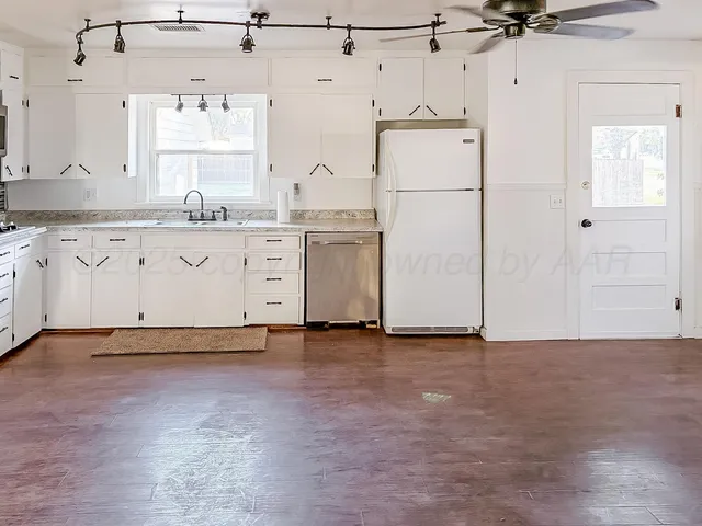 a view of a kitchen with cabinets and stainless steel appliances