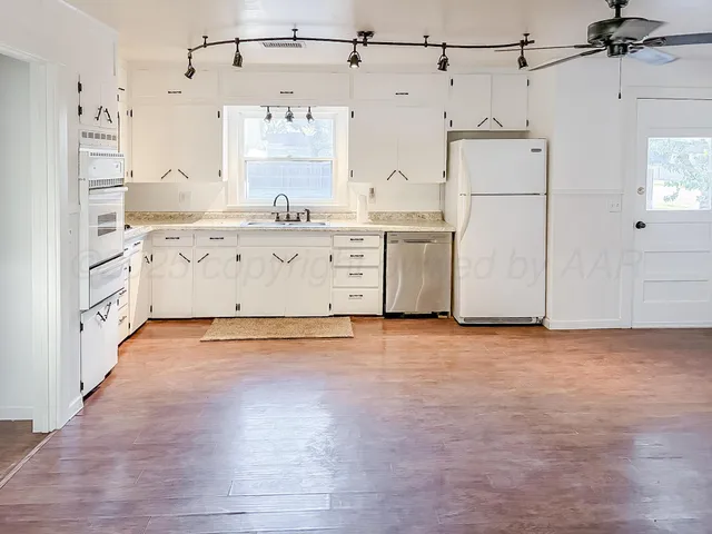a view of a kitchen with electric appliances