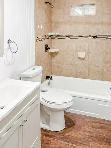 a bathroom with a toilet sink and shower