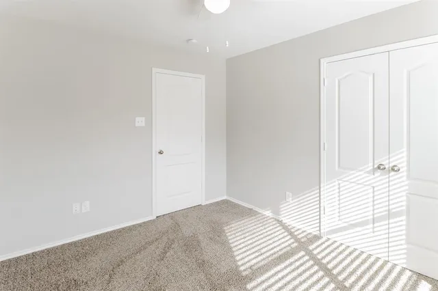 a view of a bedroom with wooden floor