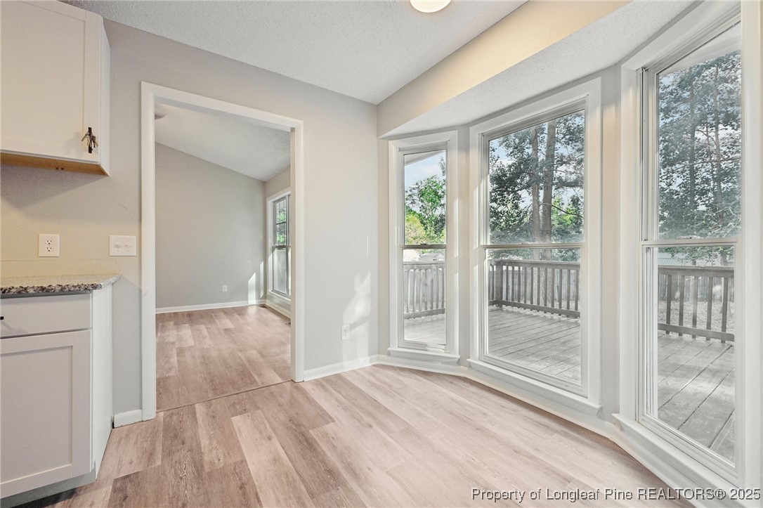 211 Lemuel Black Road Bunnlevel, NC 28323 - Photo 11 of 29 a view of empty room with wooden floor and fan