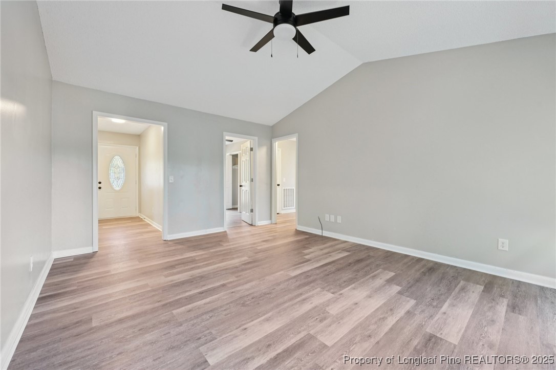 211 Lemuel Black Road Bunnlevel, NC 28323 - Photo 13 of 29 a view of a livingroom with a hardwood floor and a ceiling fan
