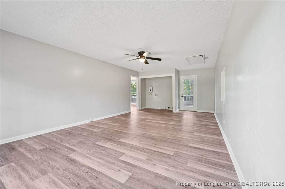 211 Lemuel Black Road Bunnlevel, NC 28323 - Photo 14 of 29 a view of a livingroom with wooden floor and a ceiling fan
