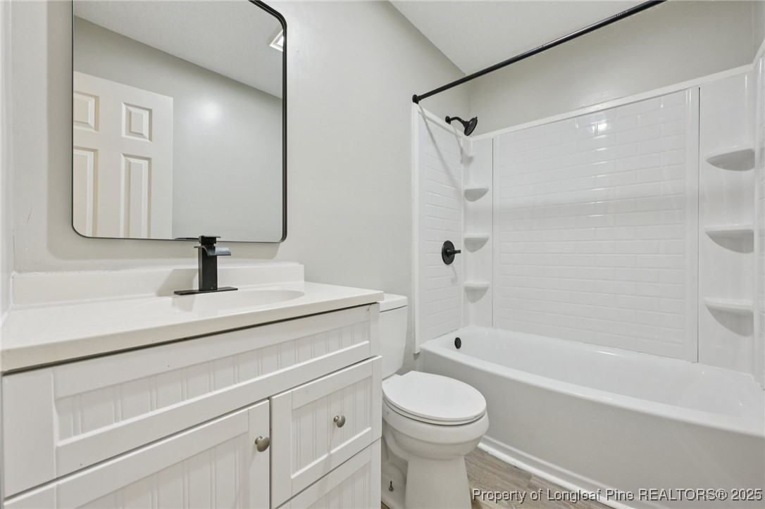 211 Lemuel Black Road Bunnlevel, NC 28323 - Photo 18 of 29 a bathroom with a sink a toilet a mirror and shower