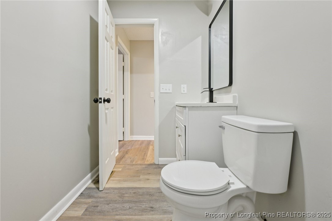 211 Lemuel Black Road Bunnlevel, NC 28323 - Photo 21 of 29 a bathroom with a granite countertop toilet and a sink