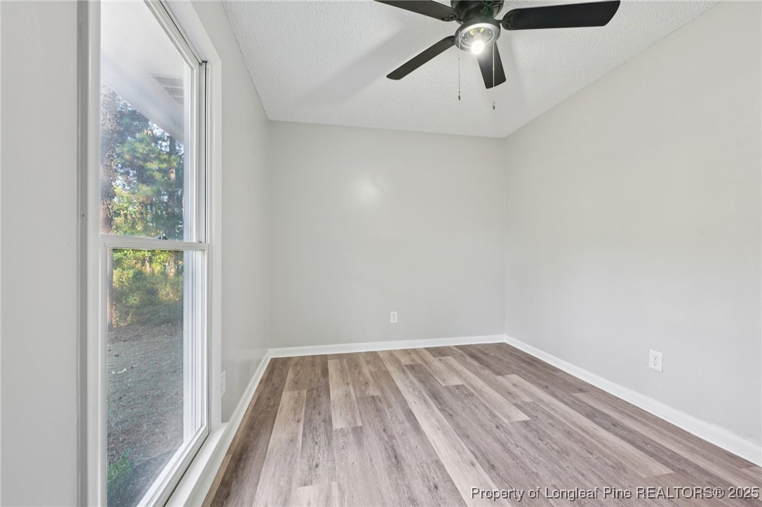 211 Lemuel Black Road Bunnlevel, NC 28323 - Photo 22 of 29 a view of a room with wooden floor and fan