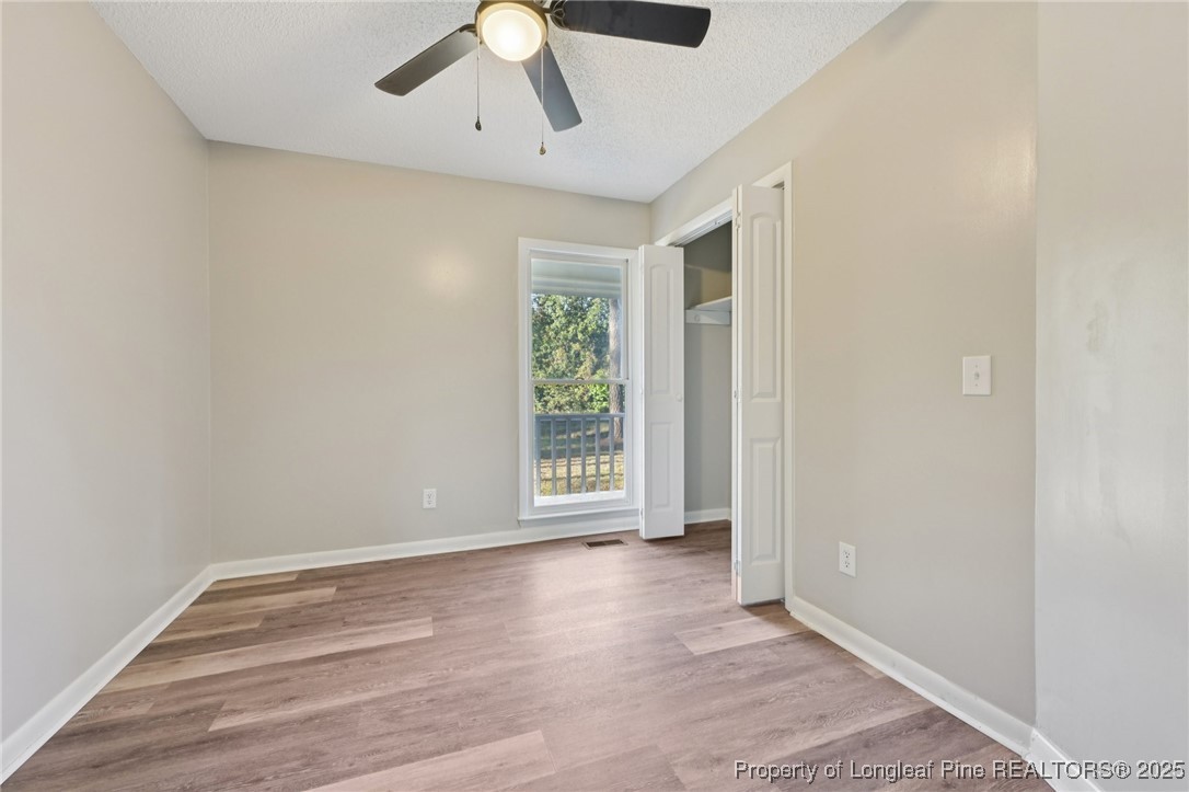 211 Lemuel Black Road Bunnlevel, NC 28323 - Photo 25 of 29 wooden floor in an empty room with a window